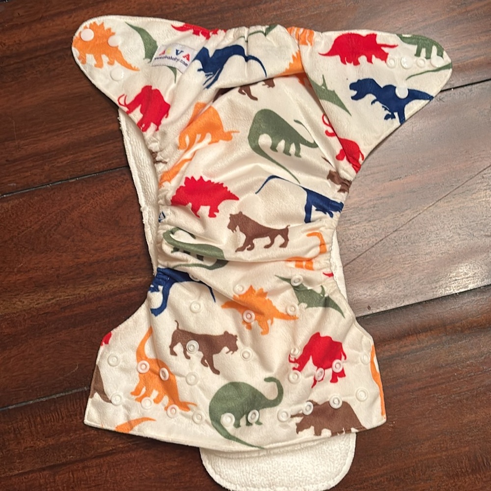 Alva Baby one-size reusable cloth pocket diaper with a dinosaur print